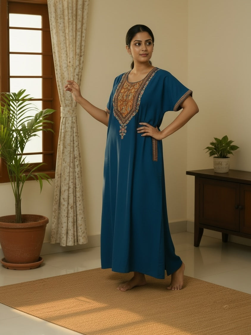 Kishona deep blue kaftan dress with intricate multi-coloured ethnic embroidery on the neckline and sleeves.