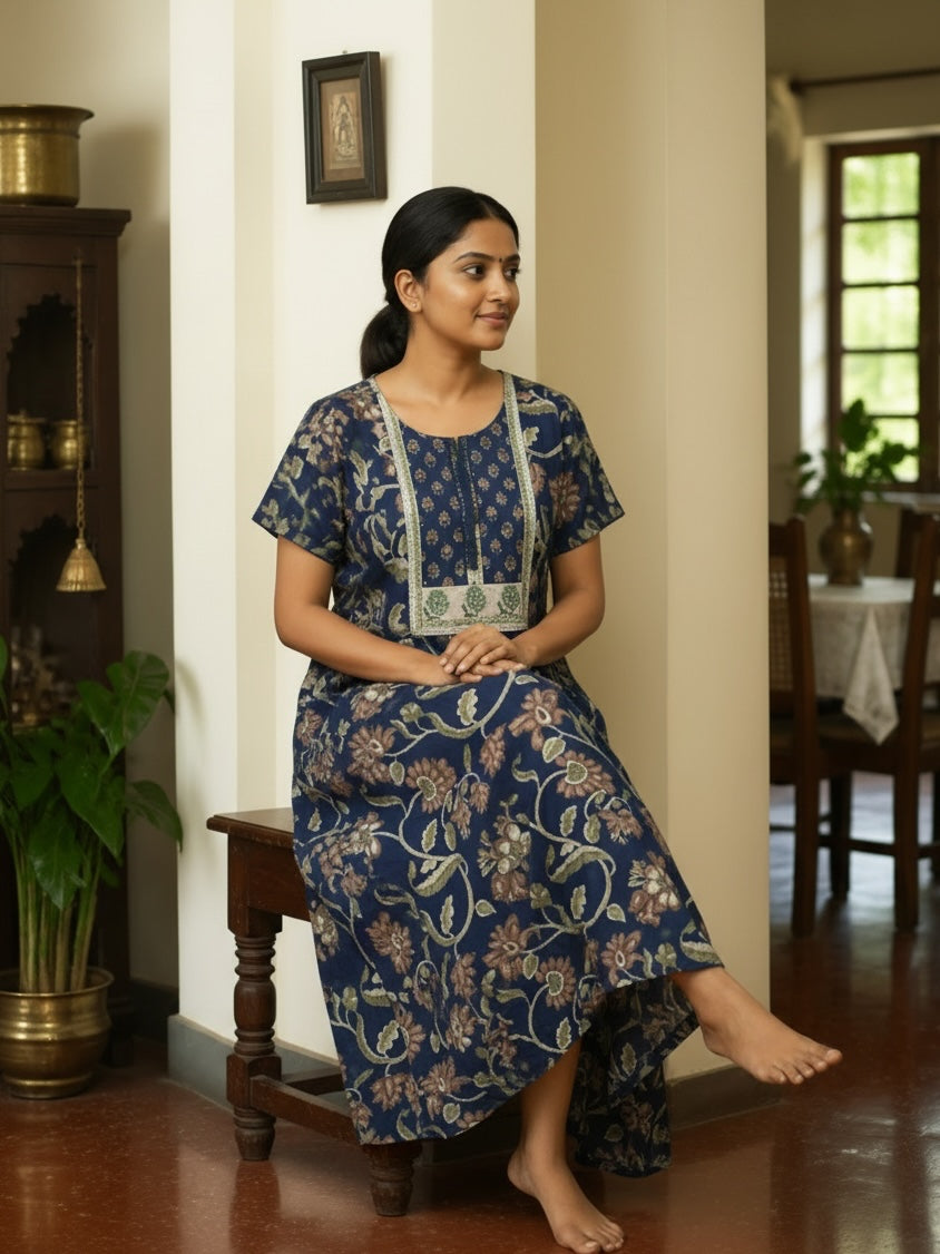 Kishona indigo blue cotton maxi dress with floral print, round neck, lace trim, and short sleeves on a seated woman.
