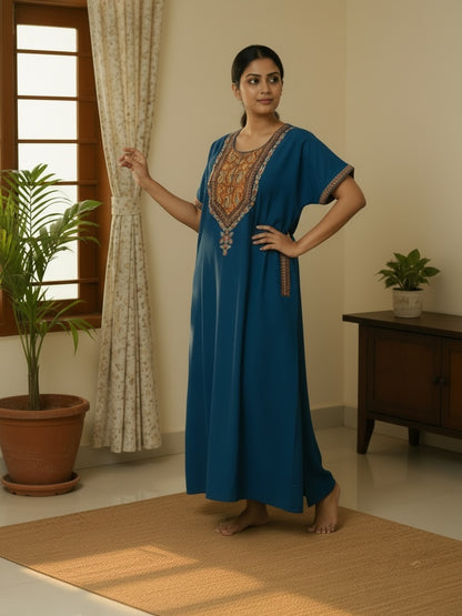 Kishona deep blue kaftan dress with intricate multi-coloured ethnic embroidery on the neckline and sleeves.