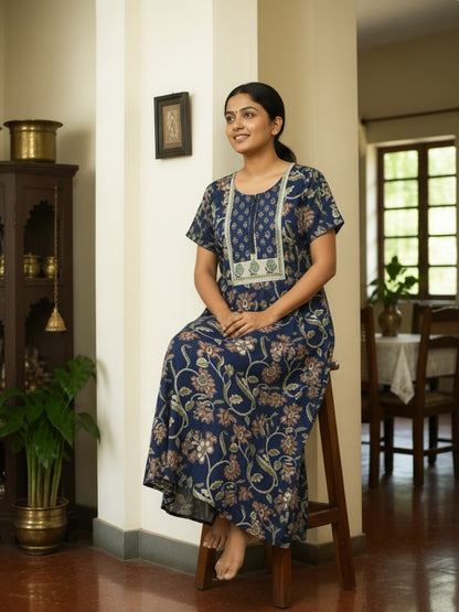 Kishona indigo blue cotton maxi dress with earthy floral prints, round neck, and delicate lace trim detailing.