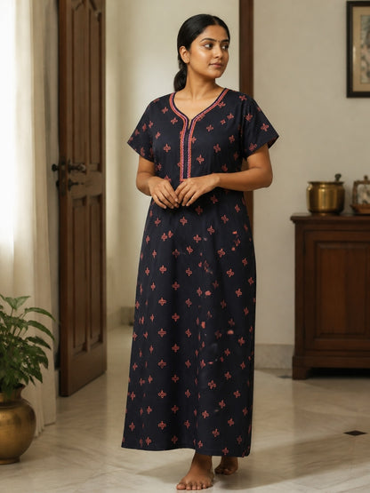 Kishona navy blue cotton nightdress with pink floral motifs and embroidered neckline worn by a woman at home