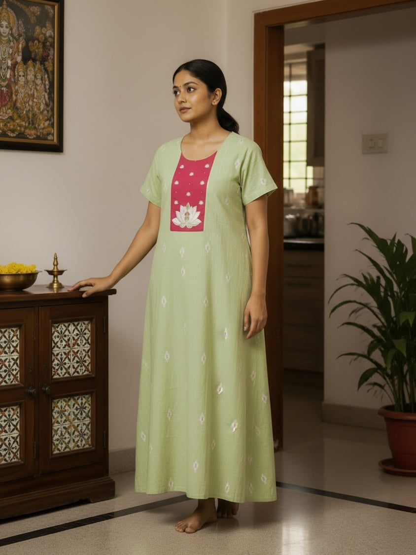 Kishona pastel green cotton maxi kurta dress with a pink lotus motif yoke and short sleeves worn by a woman